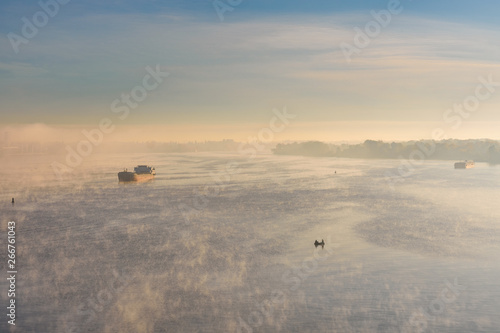 Cargo ship in fog on a river Dnieper © ihorbondarenko
