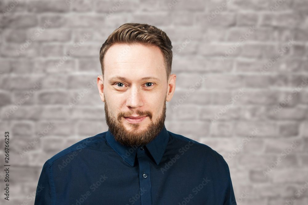 Portrait of handsome adult man on brick wall background. Caucasian man with beard smiling. Businessman. Portrait of handsome adult man on brick wall background. Caucasian man with beard smiling. Businessman.