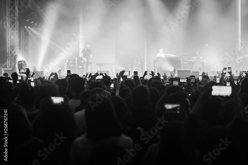 hands to the skies of people dancing and having fun at the live music concert