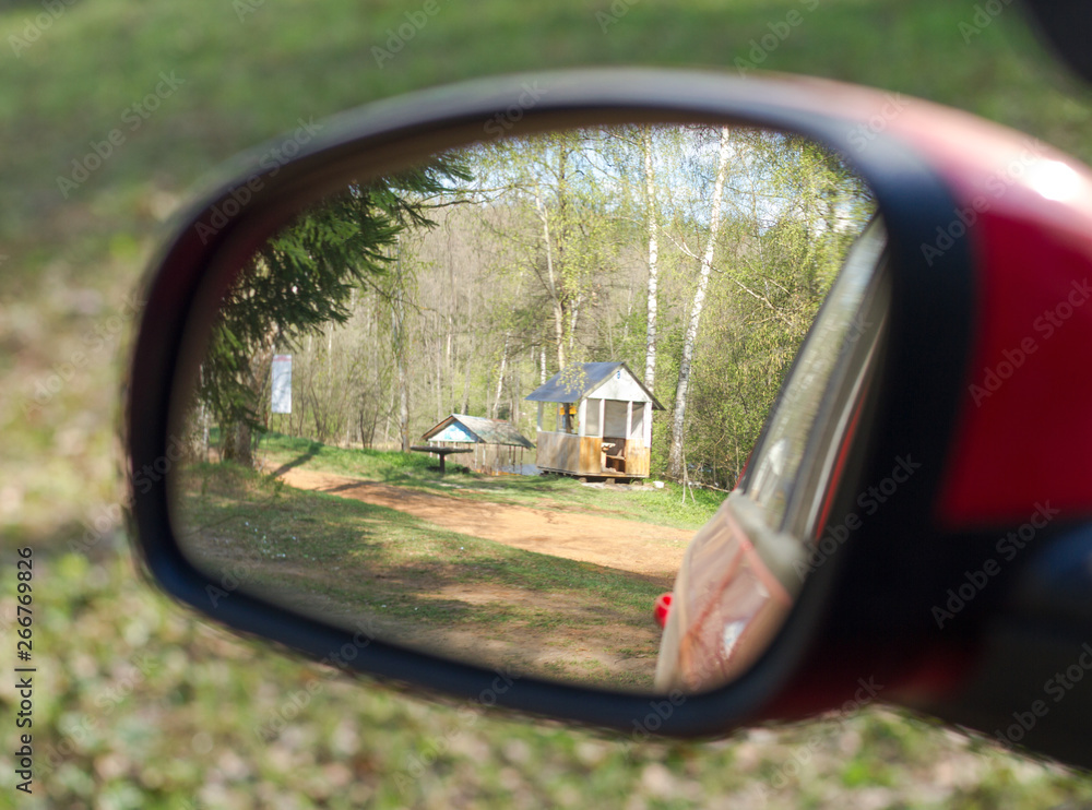 Rearview mirror with arbor in the forest. Camping concept Rearview mirror with arbor in the forest. Camping concept