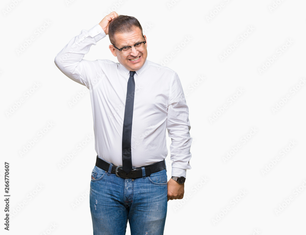 Middle age bussines arab man wearing glasses over isolated background confuse and wonder about question. Uncertain with doubt, thinking with hand on head. Pensive concept. Middle age bussines arab man wearing glasses over isolated background confuse and wonder about question. Uncertain with doubt, thinking with hand on head. Pensive concept.