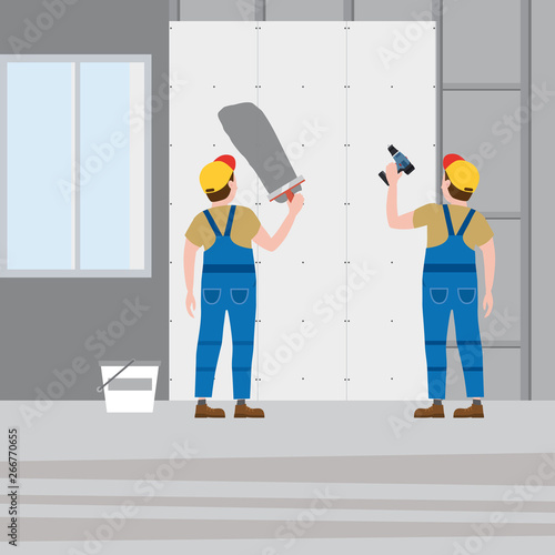 Workers put plaster, installing gypsum plasterboard panels in the interior