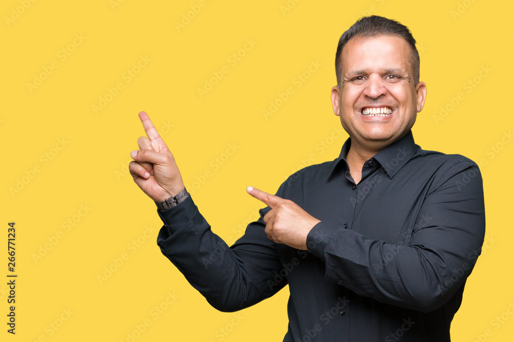 Handsome middle age arab business man over isolated background smiling and looking at the camera pointing with two hands and fingers to the side. Handsome middle age arab business man over isolated background smiling and looking at the camera pointing with two hands and fingers to the side.