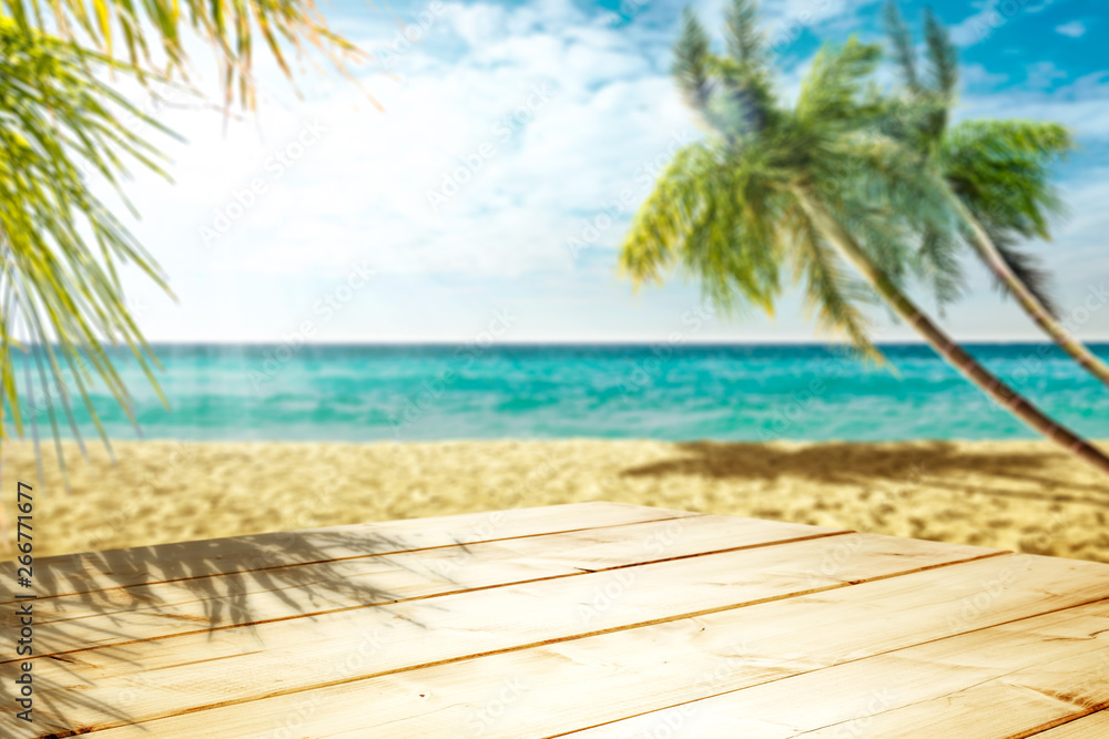 Wooden table background of free space and summer beach with palms. Wooden table background of free space and summer beach with palms.