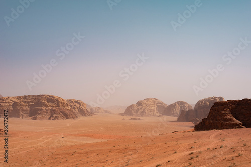 Desert hill, huge rock mountain and blue sky in Wadi Rum