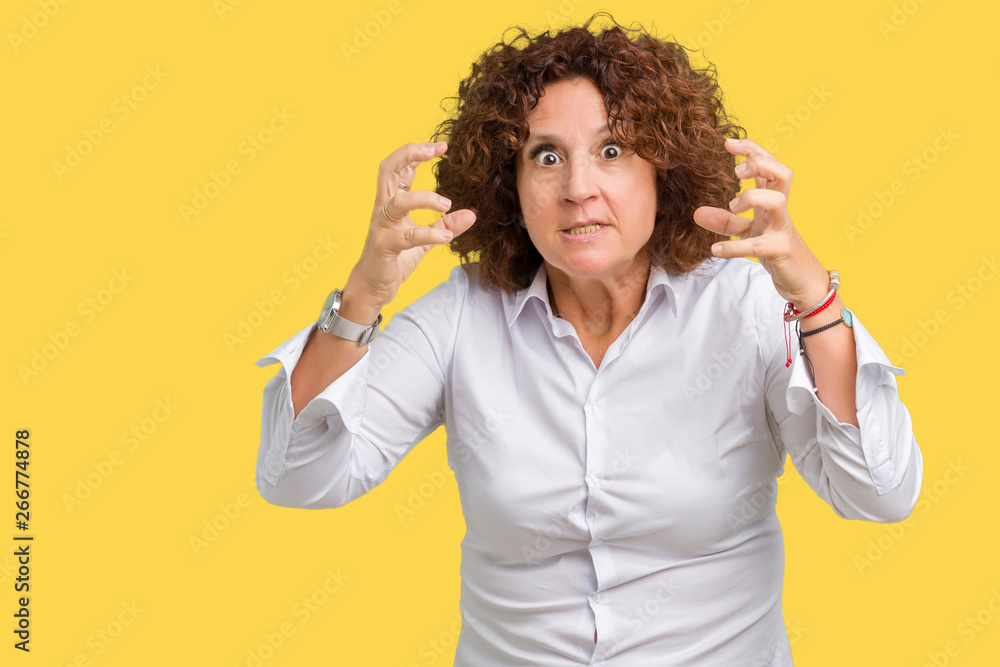 Beautiful middle ager senior businees woman over isolated background Shouting frustrated with rage, hands trying to strangle, yelling mad Beautiful middle ager senior businees woman over isolated background Shouting frustrated with rage, hands trying to strangle, yelling mad