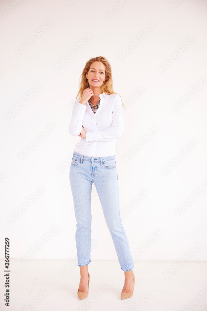 Full length shot of beautiful blond woman standing at isolated white background Full length shot of beautiful blond woman standing at isolated white background
