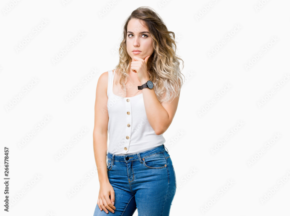 Young beautiful blonde woman over isolated background with hand on chin thinking about question, pensive expression. Smiling with thoughtful face. Doubt concept. Young beautiful blonde woman over isolated background with hand on chin thinking about question, pensive expression. Smiling with thoughtful face. Doubt concept.