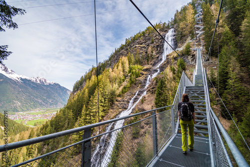 Girl alone on stairs beside Stuibenfall waterfall, Umhausen, Austria