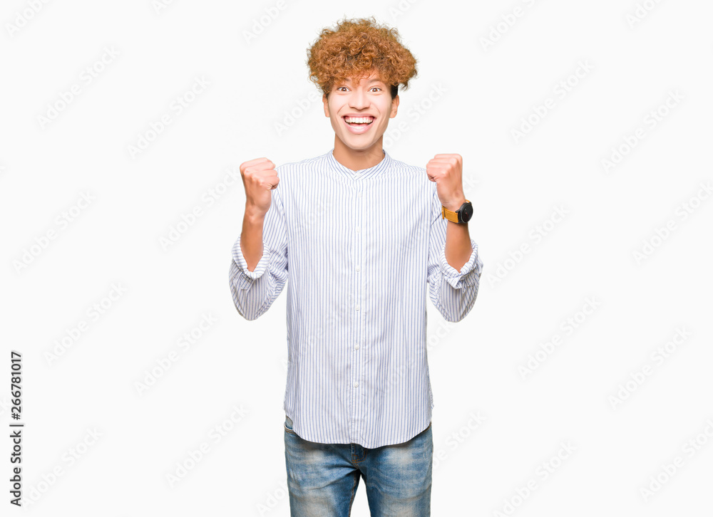 Young handsome business man with afro hair wearing elegant shirt celebrating surprised and amazed for success with arms raised and open eyes. Winner concept. Young handsome business man with afro hair wearing elegant shirt celebrating surprised and amazed for success with arms raised and open eyes. Winner concept.