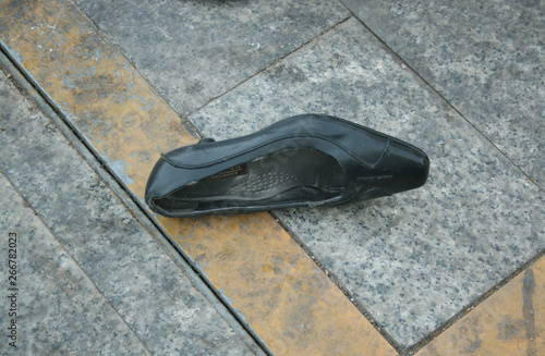 LONELY WOMAN SHOE ON THE STREET photo