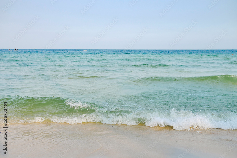Waves and sand on the tropical beach of Phu Quoc island, Vietnam. Corner of resort beach in the afternoon