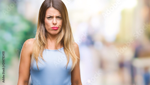 Young beautiful elegant business woman over isolated background skeptic and nervous, frowning upset because of problem. Negative person. © Krakenimages.com