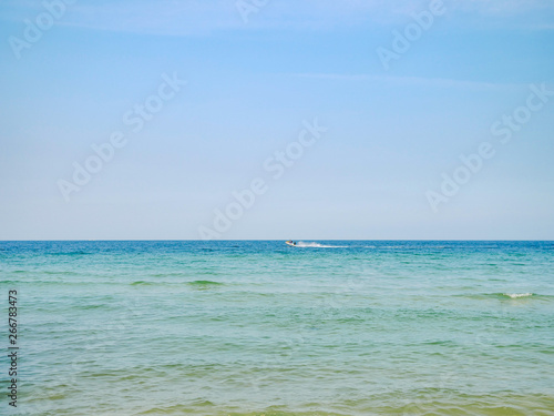 Calm waves and sand on the tropical beach of Phu Quoc island, Vietnam.