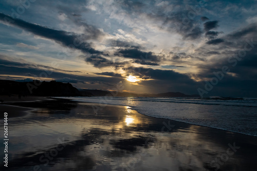 sunset on the beach of Atxabiribil  Sopelana  vizcaya. The sun is reflected on the seashore