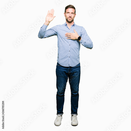Konstfotografi Handsome business man with blue eyes Swearing with hand on chest and open palm,