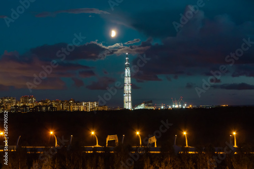 night cityscape. View of the Lakhta Center tower in St. Petersburg in the sunset with clouds and moon