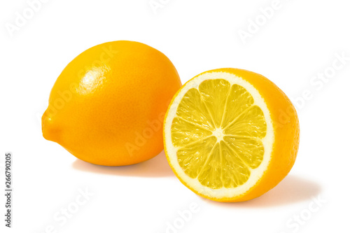 Fresh orange Tashkent lemons or Meyer lemons, one whole and one half isolated on white background with shadow photo