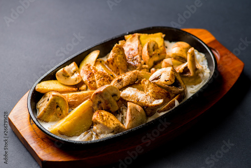 pan with potatoes, meat and mushrooms, baked in the oven