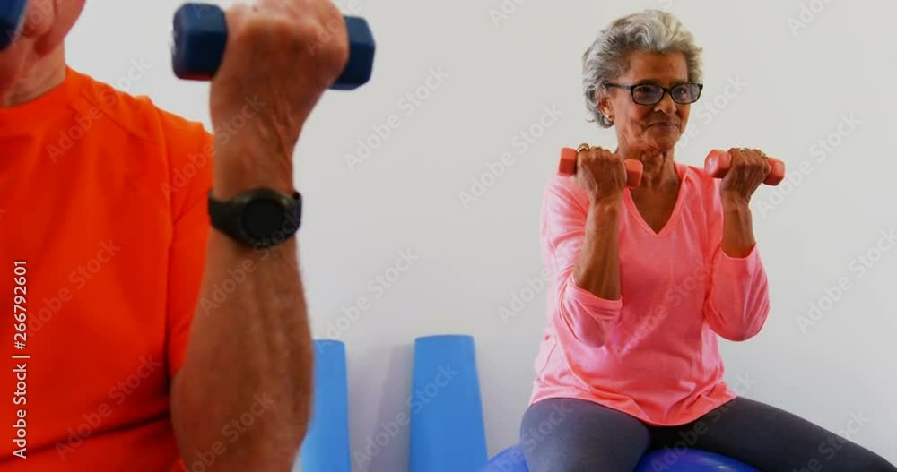 Mixed race senior people exercising with dumbbells in the fitness studio 4k Mixed race senior people exercising with dumbbells in the fitness studio 4k