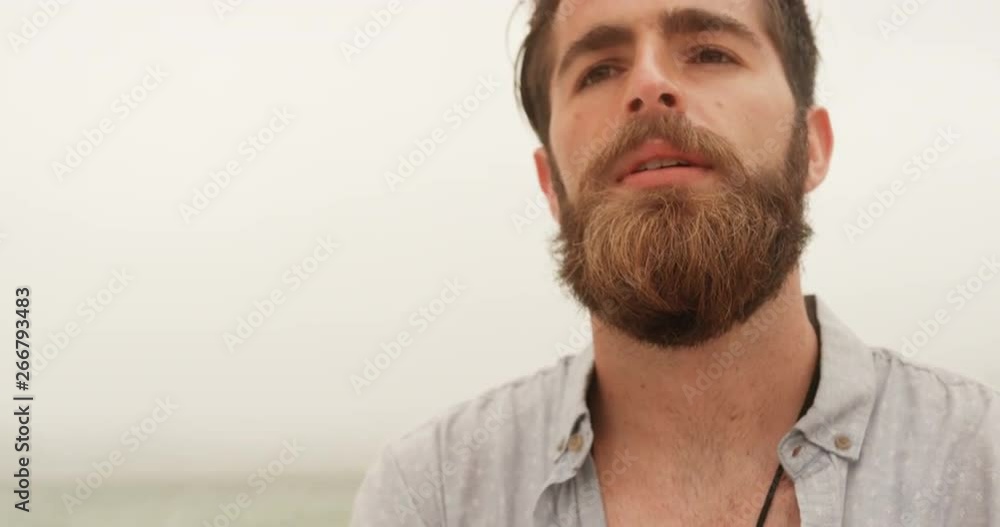 Front view of Caucasian man standing with arms crossed on the beach Front view of Caucasian man standing with arms crossed on the beach