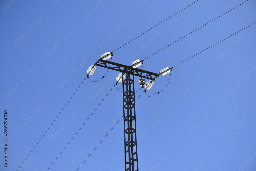 Three old power lines with a glass connection in front of a blue sky. Three old power lines with a glass connection in front of a blue sky.