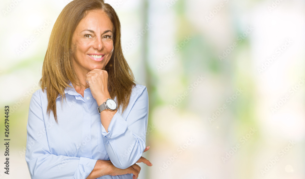 Beautiful middle age business adult woman over isolated background looking confident at the camera with smile with crossed arms and hand raised on chin. Thinking positive. Beautiful middle age business adult woman over isolated background looking confident at the camera with smile with crossed arms and hand raised on chin. Thinking positive.