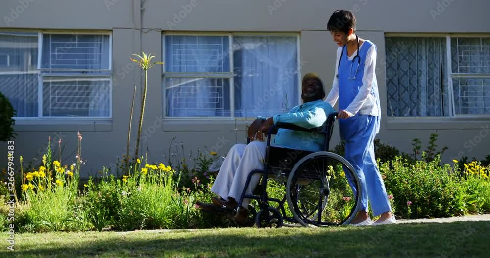 Side view of Caucasian female doctor pushing senior patient in wheelchair at nursing home 4k Side view of Caucasian female doctor pushing senior patient in wheelchair at nursing home 4k