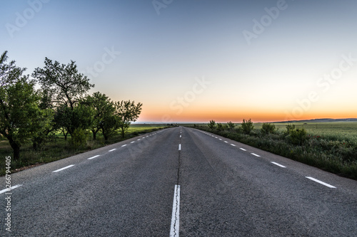 Empty asphalt road at sunset