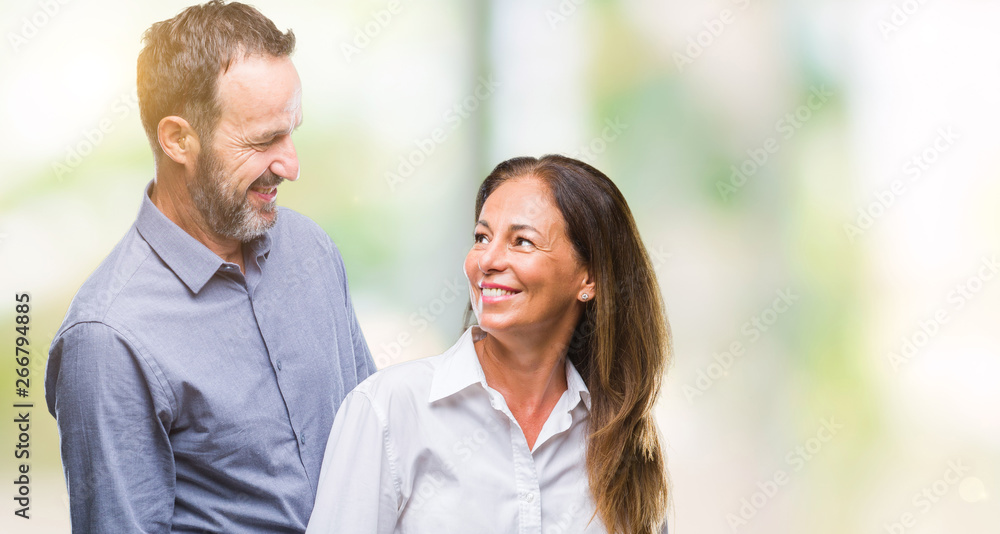 Middle age hispanic business couple over isolated background with serious expression on face. Simple and natural looking at the camera. Middle age hispanic business couple over isolated background with serious expression on face. Simple and natural looking at the camera.