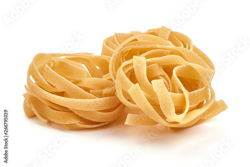 Raw tagliatelle pasta, close-up, isolated on white background