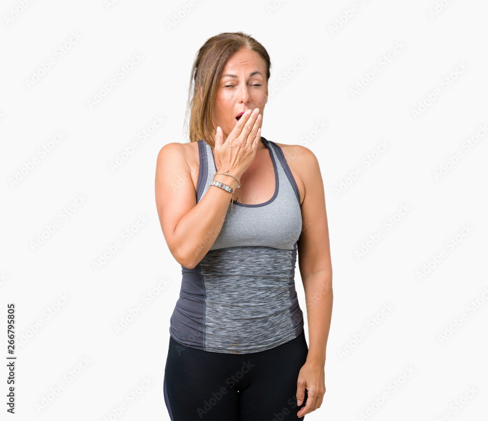 Beautiful middle age woman wearing sport clothes over isolated background bored yawning tired covering mouth with hand. Restless and sleepiness. Beautiful middle age woman wearing sport clothes over isolated background bored yawning tired covering mouth with hand. Restless and sleepiness.
