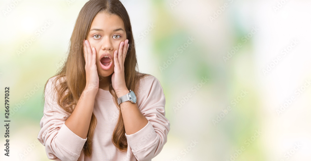 Young beautiful brunette woman wearing pink sweatshirt over isolated background afraid and shocked with surprise expression, fear and excited face. Young beautiful brunette woman wearing pink sweatshirt over isolated background afraid and shocked with surprise expression, fear and excited face.