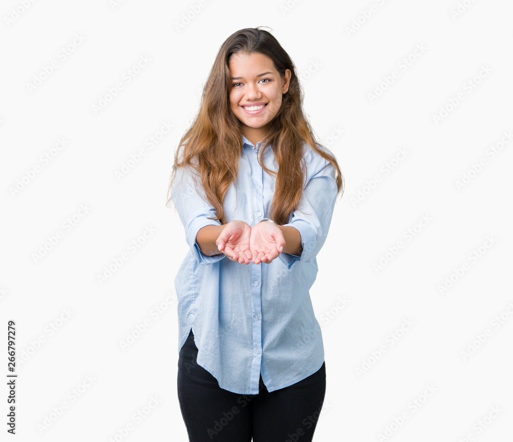 Young beautiful brunette business woman over isolated background Smiling with hands palms together receiving or giving gesture. Hold and protection Young beautiful brunette business woman over isolated background Smiling with hands palms together receiving or giving gesture. Hold and protection
