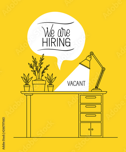office workplace with we are hiring message