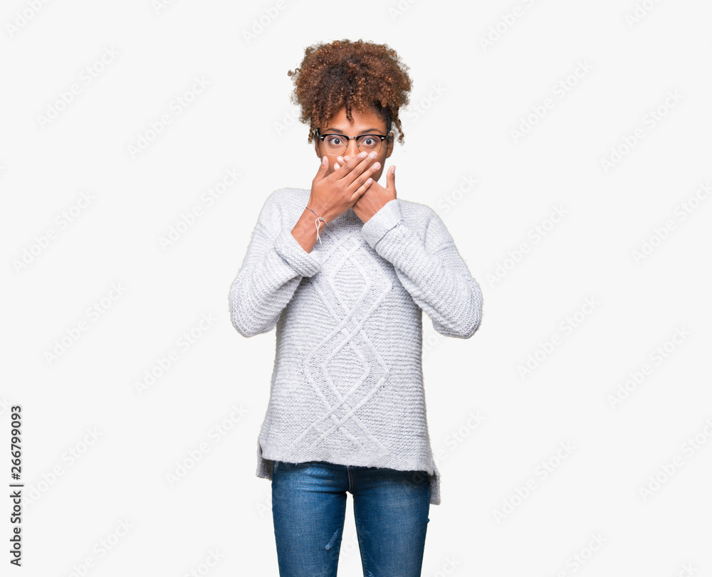 Beautiful young african american woman wearing winter sweater over isolated background shocked covering mouth with hands for mistake. Secret concept. Beautiful young african american woman wearing winter sweater over isolated background shocked covering mouth with hands for mistake. Secret concept.