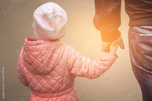 father holding daughter hand © KIWIRIN