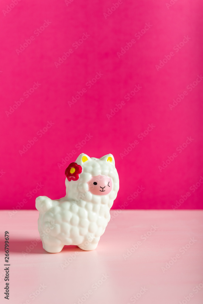 White Squishy Llama on bright pink background. Famous and popular kids toy. White Squishy Llama on bright pink background. Famous and popular kids toy.