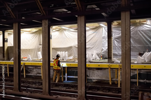 NEW YORK, USA - OCTOBER 22, 2018: Repair in New York subway. MTA worker repairing the platform of the NYC subway station photo