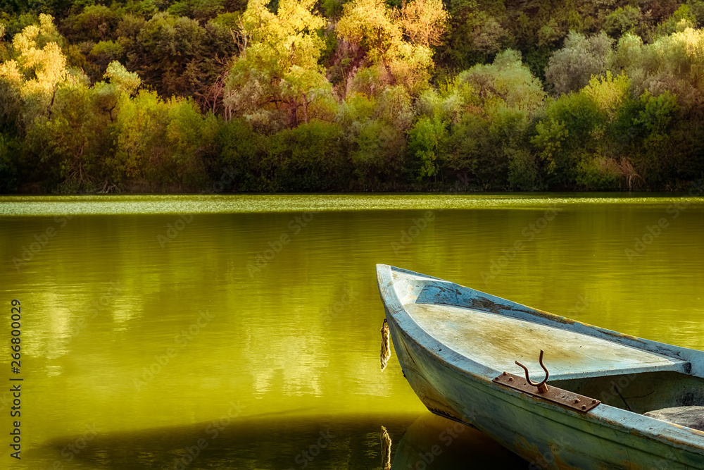 Obraz premium blue vintage boat on spring lake