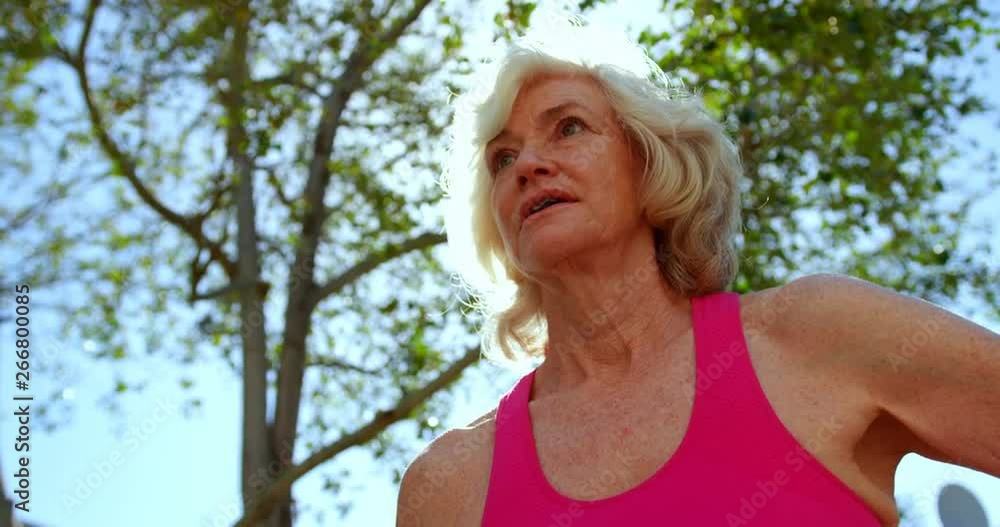 Low angle view of active Caucasian senior woman performing yoga in the garden of nursing home 4k Low angle view of active Caucasian senior woman performing yoga in the garden of nursing home 4k