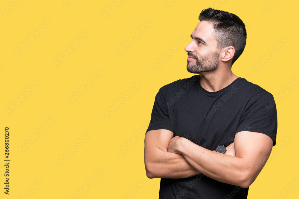 Young handsome man over isolated background smiling looking to the side with arms crossed convinced and confident Young handsome man over isolated background smiling looking to the side with arms crossed convinced and confident