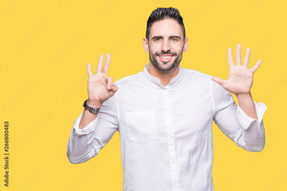 Young business man over isolated background showing and pointing up with fingers number eight while smiling confident and happy. Young business man over isolated background showing and pointing up with fingers number eight while smiling confident and happy.