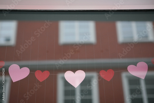 Heart Garland hanging in Store Window, Reflection of Facade