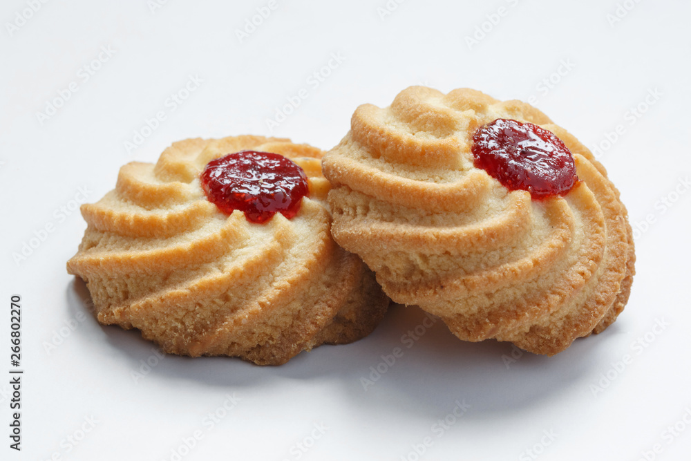 Close-up of two shortbread cookies isolated on white background.