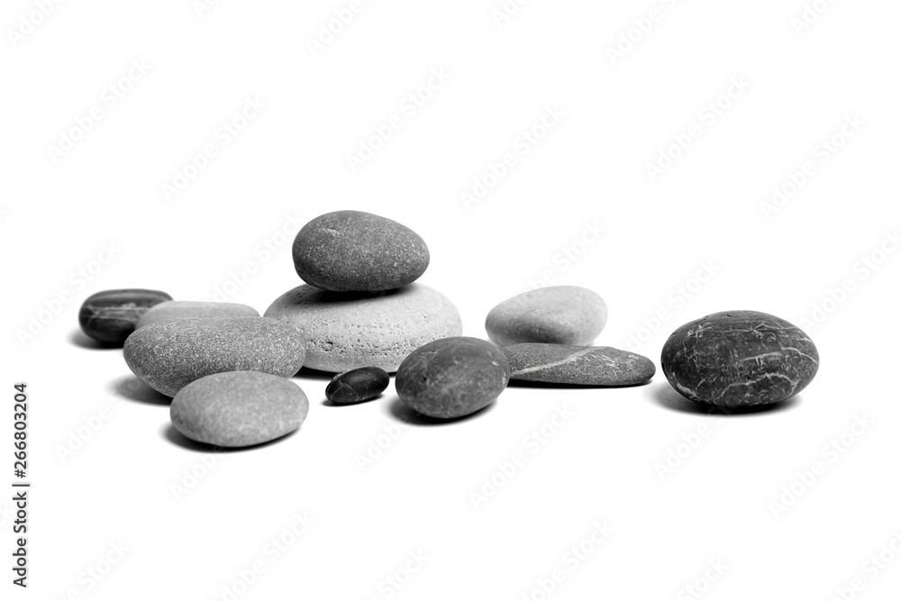 Sea pebbles. Heap of scattered and stacked smooth gray and black stones isolated on white background - obrazy, fototapety, plakaty 