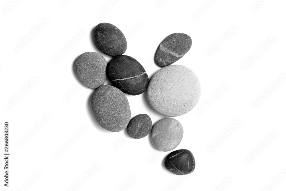 Scattered sea pebbles. Smooth gray and black stones isolated on white background. Top view Scattered sea pebbles. Smooth gray and black stones isolated on white background. Top view