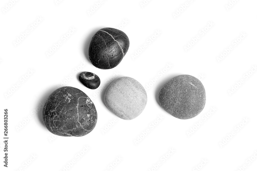 Scattered sea pebbles. Smooth gray and black stones isolated on white background. Top view Scattered sea pebbles. Smooth gray and black stones isolated on white background. Top view
