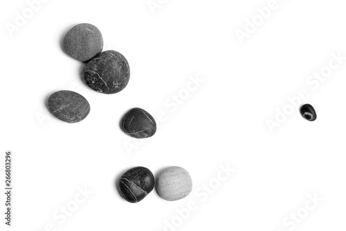 Scattered sea pebbles. Smooth gray and black stones isolated on white background. Top view