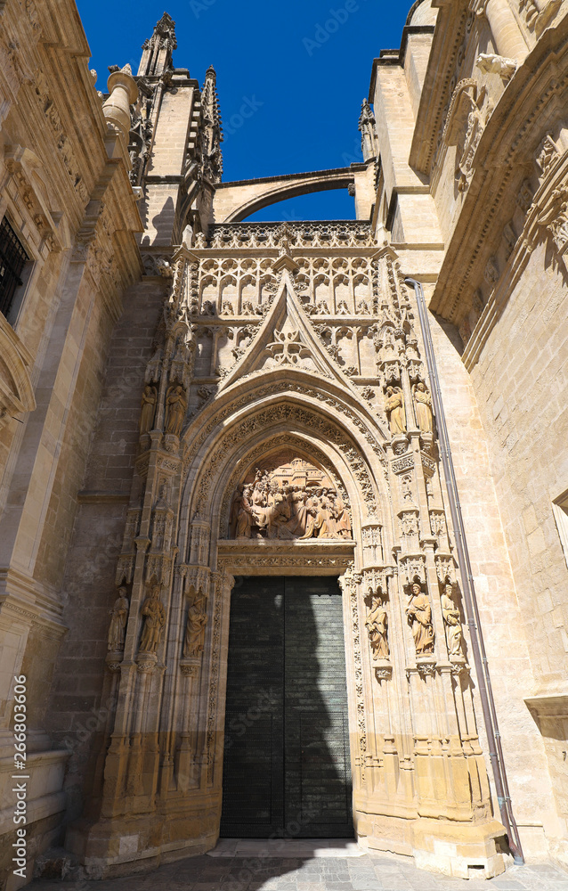 View of Seville Cathedral entry gate with the Giralda in the background
